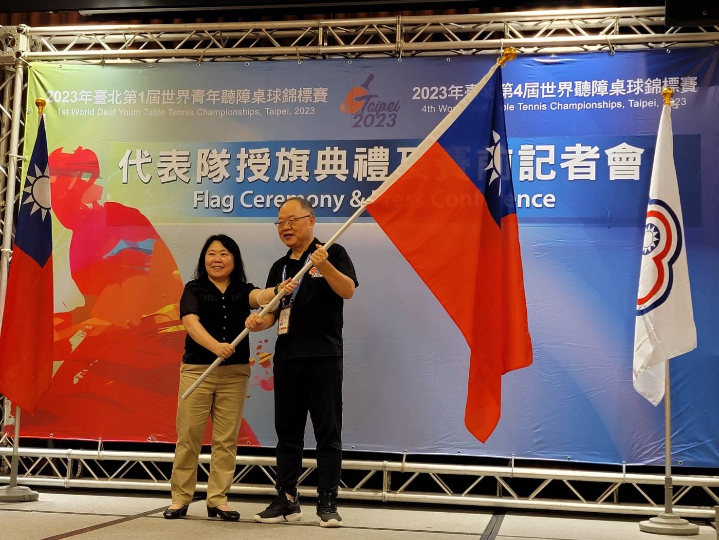 (圖)Sports Administration International and Cross-Strait Sports Division Deputy Head Yang Chu-yu (left) presented the flag of the ROC to a representative of Taiwan’s team for the 4th World Deaf Table Tennis Championship and 1st World Deaf Youth Table Tennis Championship.